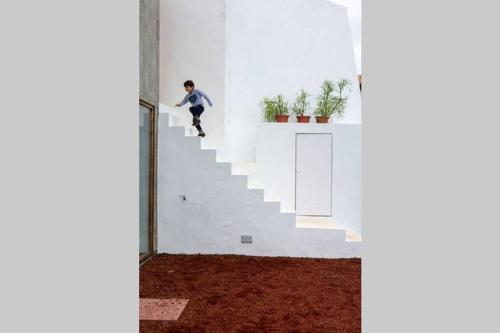 a boy riding a skateboard down the stairs at Casa das Artes in Serreta