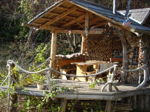 a wooden house with a table on a wooden deck at Oriana Studios in Bled