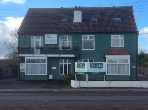 a green house with a sign in front of it at The Jays Guest House in Bristol