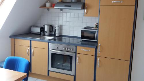 a small kitchen with a stove and a sink at Ferienwohnung Bleeken in Schneverdingen