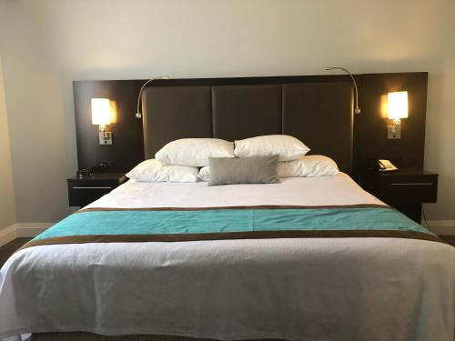 a bedroom with a large bed with two pillows at Best Western Plus Barrie in Barrie