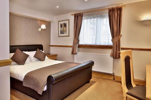 a bedroom with a bed and a window at Bury Ramsbottom Old Mill Hotel and Leisure Club in Ramsbottom