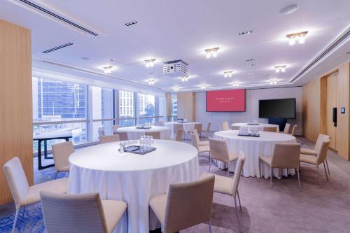 a conference room with tables and chairs and a tv at Grand Hyatt Kuala Lumpur in Kuala Lumpur