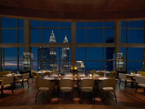 a restaurant with a view of the city at night at Grand Hyatt Kuala Lumpur in Kuala Lumpur