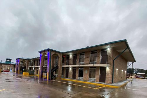 a row of buildings in a parking lot at Days Inn by Wyndham Forest in Forest