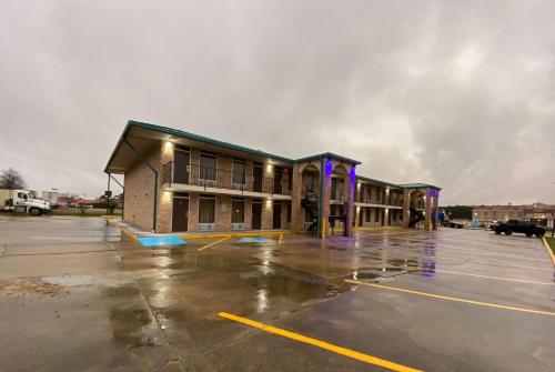 an empty parking lot in front of a building at Days Inn by Wyndham Forest in Forest