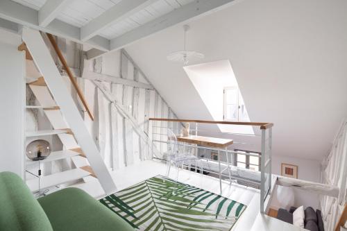 Cette chambre est dotée d'un escalier et d'une chaise verte. dans l'établissement Georgia by Cocoonr, à Rennes