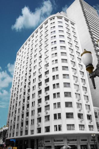 a large white building with a street light in front of it at HOTEL DEL REY CURITIBA by POTY - NA FAMOSA RUA XV DE NOVEMBRO in Curitiba
