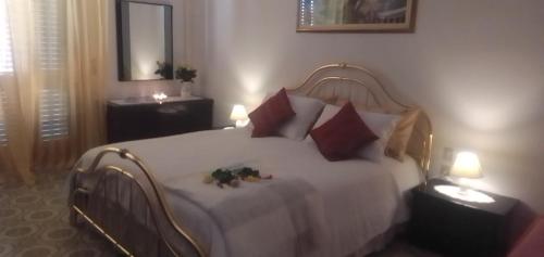 a bedroom with a bed with two stuffed animals on it at B&B Cuore e Vento in SantʼAntìoco