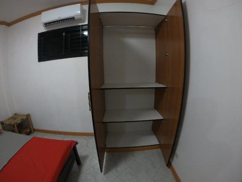 a room with a book shelf and a microwave at KJ Danish Inn in Garcia Hernandez