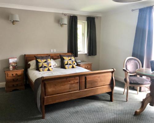 a bedroom with a bed and a table and a window at Flackley Ash Country House Hotel in Rye