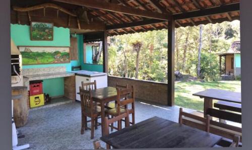 a kitchen and dining room with a table and chairs at Chalés Aguá Cristalina in Visconde De Maua