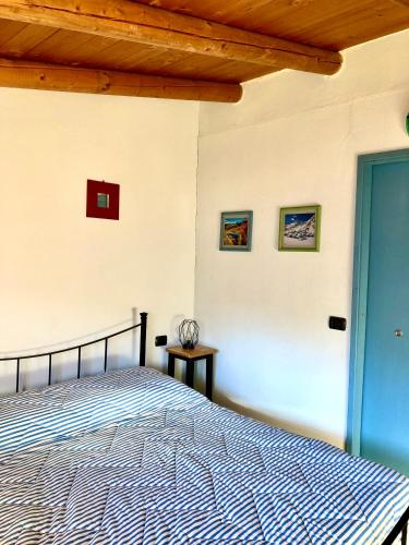 a bedroom with a bed and three pictures on the wall at Agriturismo Cavria in Castione Andevenno
