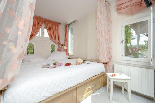 a bedroom with a large bed with dolls on it at Katerinas villa in Agia Anna Naxos