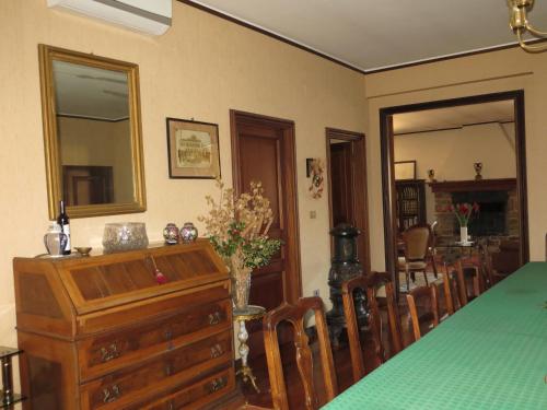 a dining room with a table and a mirror at B&B ABBAZIA Sant'ELENA in Serra San Quirico