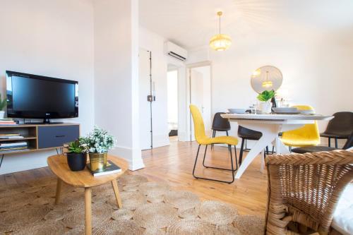 a living room with a table and a dining room at Lucky Number 79 - UNESCO World Heritage Penthouse in Coimbra