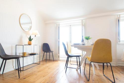 a dining room with chairs and a table and a mirror at Lucky Number 79 - UNESCO World Heritage Penthouse in Coimbra