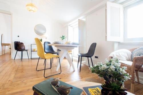 a living room with a table and chairs at Lucky Number 79 - UNESCO World Heritage Penthouse in Coimbra