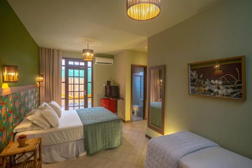 Ένα ή περισσότερα κρεβάτια σε δωμάτιο στο Pousada Villa Maeva Itacimirim