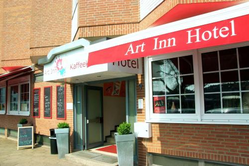 a building with an art inn hotel sign on it at Hotel Art Inn Dinslaken in Dinslaken