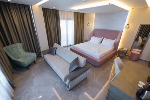 a hotel room with a bed and a couch at Brilliant Hotel & SPA in Golem