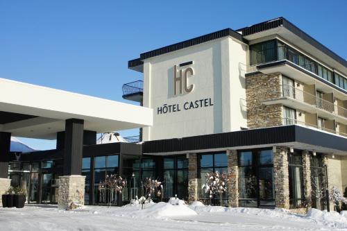 a hotel caseline building with snow in front of it at Hôtel Castel in Granby