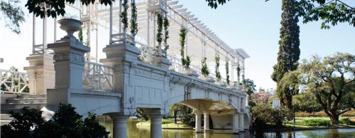 a white bridge in a park with trees at Bulnes Eco Suites in Buenos Aires