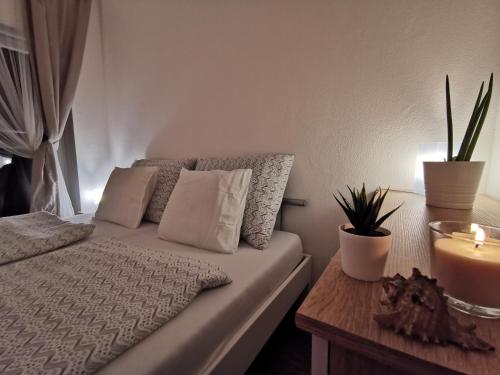 a bedroom with a bed and a table with a candle at Haas Apartments Downtown with Parking in Brno