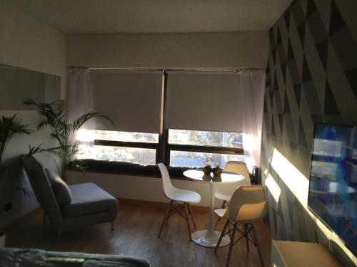 sala de estar con mesa, sillas y ventana en BUENOS AIRES BEST SKYSCRAPER en Buenos Aires