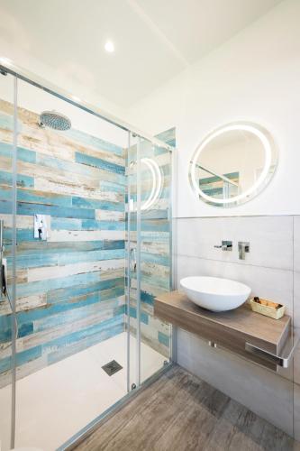a bathroom with a glass shower and a sink at Vento di mare in Procida