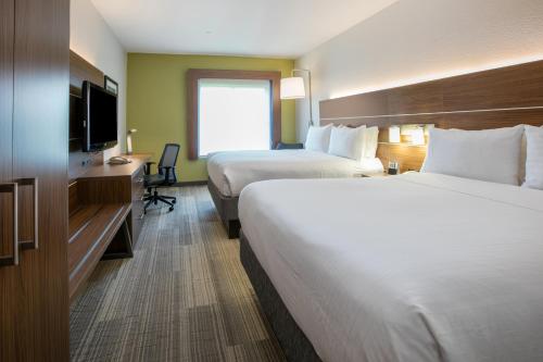 a hotel room with two beds and a television at Holiday Inn Express Hotel & Suites Dallas - Grand Prairie I-20 by IHG in Grand Prairie