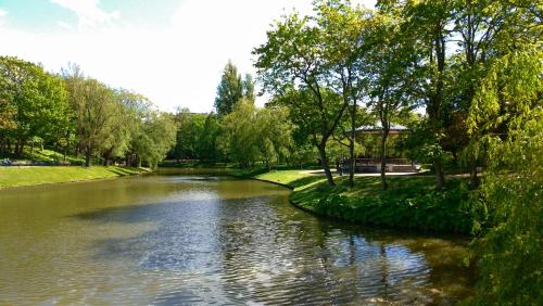 a river with trees on the side of it at Belle de Nuit in Ostend