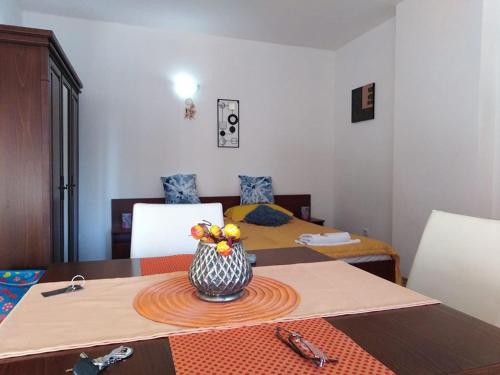 a room with a table with a vase on it at Спа,ски апартамент Дайли, Стрийм Ризорт Пампорово in Pamporovo