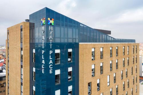a building with three people on top of it at Hyatt Place Bogota Convention Center in Bogotá