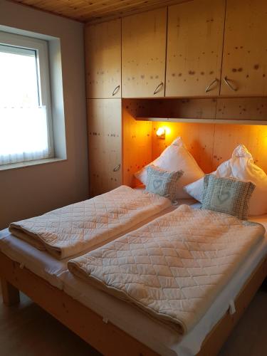 a bedroom with a large bed with a wooden headboard at Sandburg in Schillig