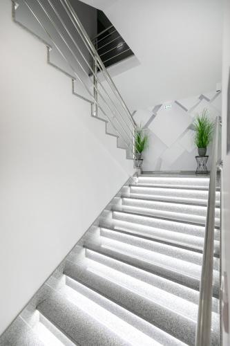 a staircase in a building with potted plants at River Inn in Stari Banovci