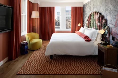a hotel room with a bed and a television at Riggs Washington DC in Washington