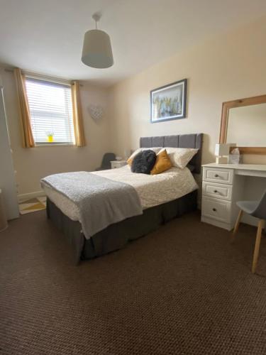 a bedroom with a bed with a stuffed animal on it at River bank apartment in Bethesda