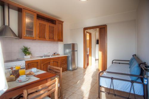 a kitchen with a bed and a table in a room at Evianna Studios in Mousata