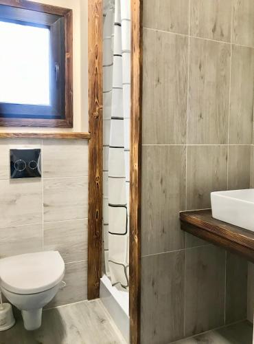 a bathroom with a toilet and a sink at A Morze Ustka in Ustka