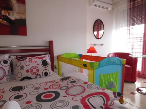 a bedroom with a bed and a table and a chair at Apartments Jovan city center with free parking in Ohrid