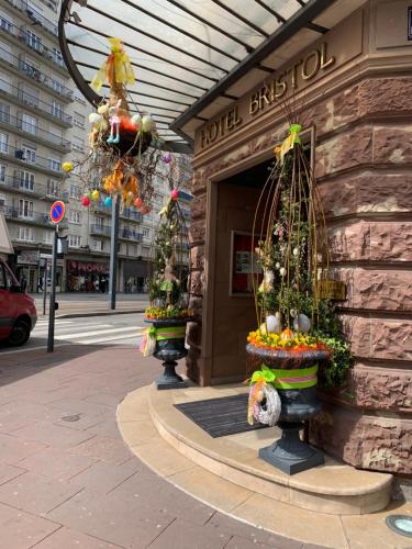a building with christmas trees inront of a store at Hotel Bristol in Mulhouse
