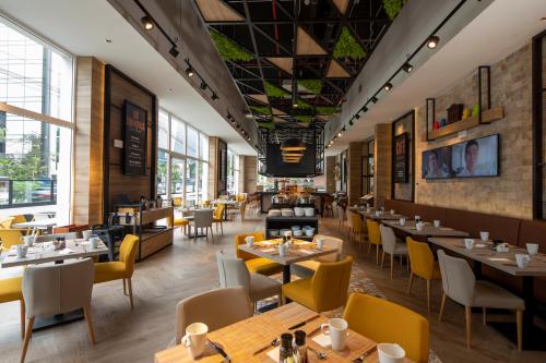 a restaurant with tables and chairs and windows at Casa Andina Premium San Isidro in Lima