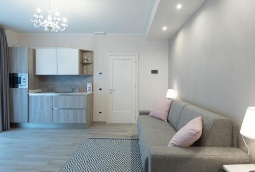 a living room with a couch and a kitchen at Residenza Conca Verde B&B la Suite in Rogolo