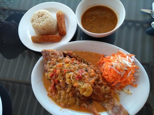 a table with two plates of food and a bowl of soup at La Rivera Playa Palomino in Palomino