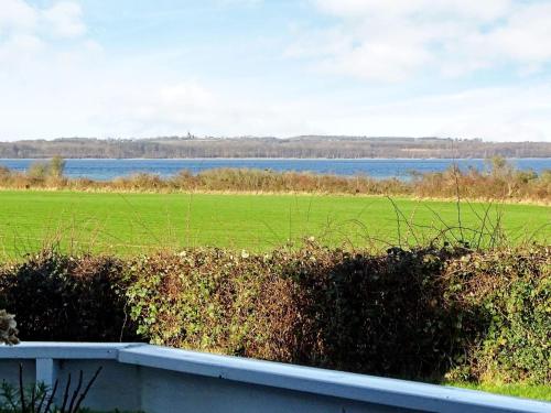 a view of a field and water from a house at 6 person holiday home in Svendborg in Svendborg