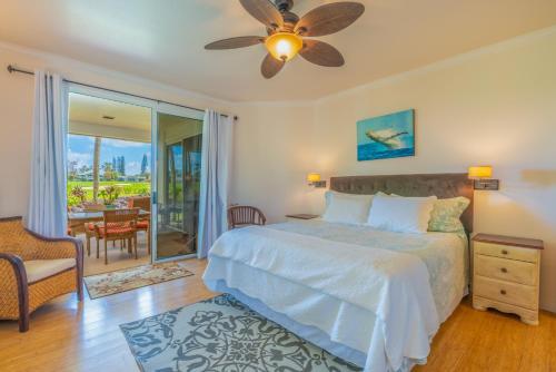 a bedroom with a bed and a ceiling fan at Hale Emmalani #311 condo in Princeville