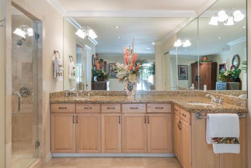 a bathroom with two sinks and a large mirror at Kailua Beachside home in Kailua