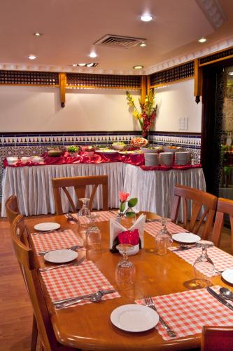 a table in a restaurant with a table set up at Landmark Plaza Hotel in Dubai