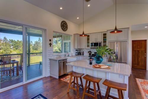 a kitchen with a large island with bar stools at Pua Lani in Keaau